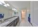 Bathroom with double sinks, granite countertops, and a view of the shower/bath area at 10072 Sage Creek Dr, Ruskin, FL 33573