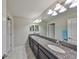Bathroom with double sinks, granite countertops, and plenty of light at 10072 Sage Creek Dr, Ruskin, FL 33573
