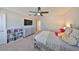 Bedroom featuring a flat-screen TV, a bed, a dresser and neutral-colored walls at 10072 Sage Creek Dr, Ruskin, FL 33573