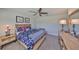 Comfortable bedroom featuring a patterned bedspread, wooden frame, neutral walls, and decorative lighting at 10072 Sage Creek Dr, Ruskin, FL 33573