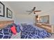 Comfortable bedroom featuring stylish wood furniture, a ceiling fan and a bright window at 10072 Sage Creek Dr, Ruskin, FL 33573