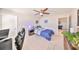 Cozy bedroom with ceiling fan, a nightstand, and view into a shared entertainment/game room at 10072 Sage Creek Dr, Ruskin, FL 33573