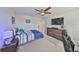 Bedroom featuring a large flat-screen TV, a desk, and a comfortable-looking bed at 10072 Sage Creek Dr, Ruskin, FL 33573