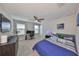 Bedroom featuring a ceiling fan, a flat-screen TV, a desk area, and a comfortable-looking bed at 10072 Sage Creek Dr, Ruskin, FL 33573