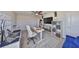 Home office space, featuring a custom desk, chair, shelving and a TV at 10072 Sage Creek Dr, Ruskin, FL 33573