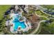 Aerial shot of a large community pool area with seating, playground, and landscaped grounds at 10072 Sage Creek Dr, Sun City Center, FL 33573