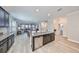 Open-concept kitchen with stainless steel appliances and a large center island at 10072 Sage Creek Dr, Ruskin, FL 33573