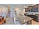 Elegant kitchen island with seating and modern appliances with stairs nearby at 10072 Sage Creek Dr, Ruskin, FL 33573