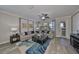 Bright living room featuring a modern ceiling fan, stylish blue rug, and cozy seating at 10072 Sage Creek Dr, Ruskin, FL 33573