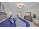 Large main bedroom features a treadmill, dresser with mirror, and a view of the bath at 10072 Sage Creek Dr, Ruskin, FL 33573