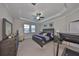 Spacious main bedroom features tray ceiling, large windows, and a modern ceiling fan at 10072 Sage Creek Dr, Ruskin, FL 33573