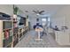 Home office area featuring a ceiling fan, two desks, a TV and a storage at 10072 Sage Creek Dr, Ruskin, FL 33573