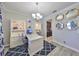 Elegant home office with stylish blue rug, modern desk, custom cabinetry, and decorative mirrors at 10072 Sage Creek Dr, Ruskin, FL 33573