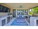Outdoor patio with a built-in kitchen, tv and comfortable seating at 10072 Sage Creek Dr, Ruskin, FL 33573