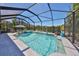 Screened-in pool with spa overlooking beautiful landscaping and serene lake at 10072 Sage Creek Dr, Ruskin, FL 33573