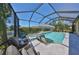 Screened-in pool with spa overlooking beautiful landscaping and serene lake at 10072 Sage Creek Dr, Ruskin, FL 33573