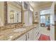 Bathroom featuring granite countertops, decorative mirrors and cabinetry with access to bedroom at 1108 W Charter St, Tampa, FL 33602