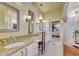Bright bathroom with double sinks, granite countertops, decorative mirrors, and access to the main bedroom at 1108 W Charter St, Tampa, FL 33602