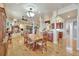 Open-concept dining area with hardwood floors, traditional furniture, and a cozy fireplace in the background at 1108 W Charter St, Tampa, FL 33602