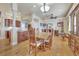Elegant dining area featuring hardwood floors, a wooden table set, and views of the adjacent kitchen at 1108 W Charter St, Tampa, FL 33602