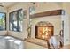 Cozy sunroom with an eye-catching fireplace, detailed stonework, and tile flooring at 1108 W Charter St, Tampa, FL 33602