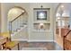 Charming foyer with staircase, stylish decor, and archways, offering a warm welcome into the home at 1108 W Charter St, Tampa, FL 33602