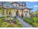 Picturesque home showcasing a stone archway, a water fountain, and lovely landscaping around the entrance at 1108 W Charter St, Tampa, FL 33602