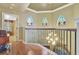 Hallway with hardwood floors, chandelier and three colorful arched windows at 1108 W Charter St, Tampa, FL 33602