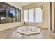Well-lit sunroom featuring an octagonal hot tub, large windows, and tile flooring at 1108 W Charter St, Tampa, FL 33602