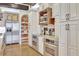 This immaculate kitchen has stainless steel appliances, white custom cabinets, and granite countertops at 1108 W Charter St, Tampa, FL 33602