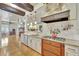 An open kitchen has granite counters, stainless appliances, and dark wood beam accents that create a chef-inspired space at 1108 W Charter St, Tampa, FL 33602