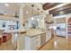 An open floorplan kitchen features granite counters, stainless appliances, and dark wood beam accents that create a chef's dream at 1108 W Charter St, Tampa, FL 33602