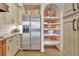 This contemporary kitchen has stainless appliances, granite counters, and custom shelving for storage at 1108 W Charter St, Tampa, FL 33602