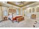 Spacious main bedroom with neutral tones and tray ceiling featuring a wooden four poster bed and elegant furnishings at 1108 W Charter St, Tampa, FL 33602