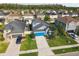 Wonderful home with a bright blue garage door nestled in a neighborhood with mature trees and well-kept lawns at 1571 Montgomery Bell Rd, Wesley Chapel, FL 33543