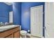 Cozy bathroom featuring granite countertop and a blue accent wall at 1571 Montgomery Bell Rd, Wesley Chapel, FL 33543