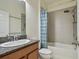 Bathroom featuring a combination shower and tub, modern fixtures, and neutral tones at 1571 Montgomery Bell Rd, Wesley Chapel, FL 33543