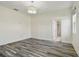 Spacious bedroom with wood-look floors, neutral walls, and ensuite bathroom access at 1571 Montgomery Bell Rd, Wesley Chapel, FL 33543