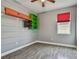 Stylish bedroom showcasing wood-look floors, built-in storage, and a bright window at 1571 Montgomery Bell Rd, Wesley Chapel, FL 33543