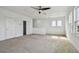Open bonus room with carpet, ceiling fan, natural light, and access doors at 1571 Montgomery Bell Rd, Wesley Chapel, FL 33543