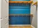 Walk-in closet with blue accent wall, shelving and ample storage space at 1571 Montgomery Bell Rd, Wesley Chapel, FL 33543