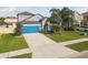 Beautiful two-story home with a blue garage door, mature landscaping, and a well-manicured lawn at 1571 Montgomery Bell Rd, Wesley Chapel, FL 33543