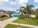 Beautiful home with a vibrant blue garage door, lush landscaping, and well-maintained lawn at 1571 Montgomery Bell Rd, Wesley Chapel, FL 33543