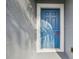 Stylish blue front door with white trim accents on a gray exterior, creating an inviting entrance at 1571 Montgomery Bell Rd, Wesley Chapel, FL 33543