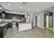 Open-concept kitchen featuring granite countertops, stainless appliances, and a central island at 1571 Montgomery Bell Rd, Wesley Chapel, FL 33543