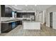 Spacious kitchen features dark cabinets, stainless steel appliances, granite counters, and island at 1571 Montgomery Bell Rd, Wesley Chapel, FL 33543