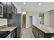 The kitchen showcases dark cabinets, granite countertops, and stainless appliances, offering a modern and stylish culinary space at 1571 Montgomery Bell Rd, Wesley Chapel, FL 33543