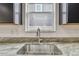 Close up of kitchen sink with granite counter and stainless steel faucet and basin at 1571 Montgomery Bell Rd, Wesley Chapel, FL 33543