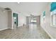 Bright, open living room with tile floors, neutral walls, and sliding glass doors at 1571 Montgomery Bell Rd, Wesley Chapel, FL 33543