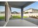 Covered patio with gravel and grass landscaping, offering serene outdoor living at 1571 Montgomery Bell Rd, Wesley Chapel, FL 33543